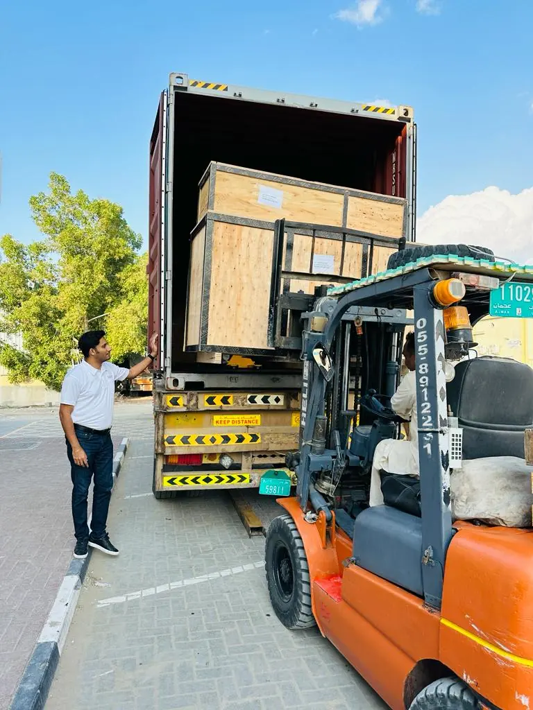 Crated household goods loaded onto a truck by forklift