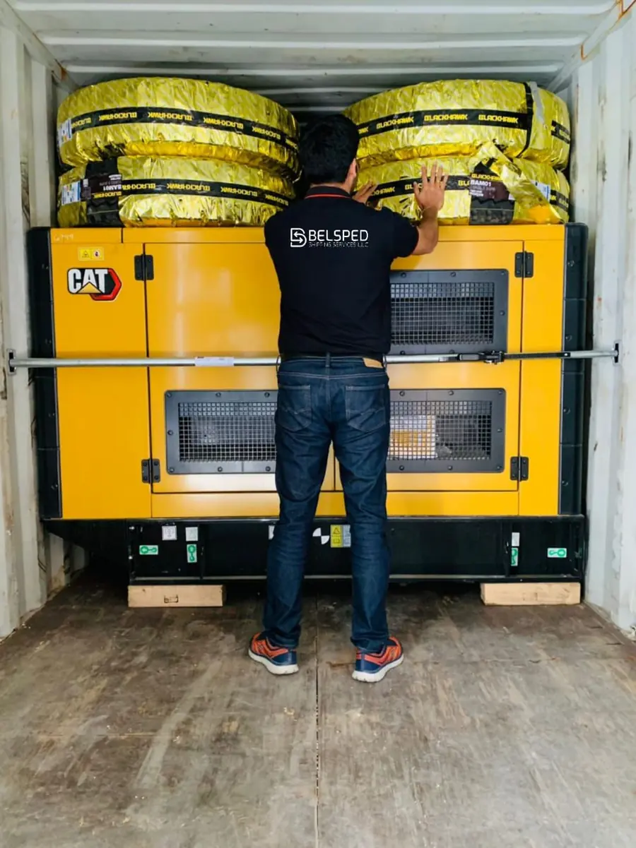 Belsped Shipping team member securing a generator inside a container for export